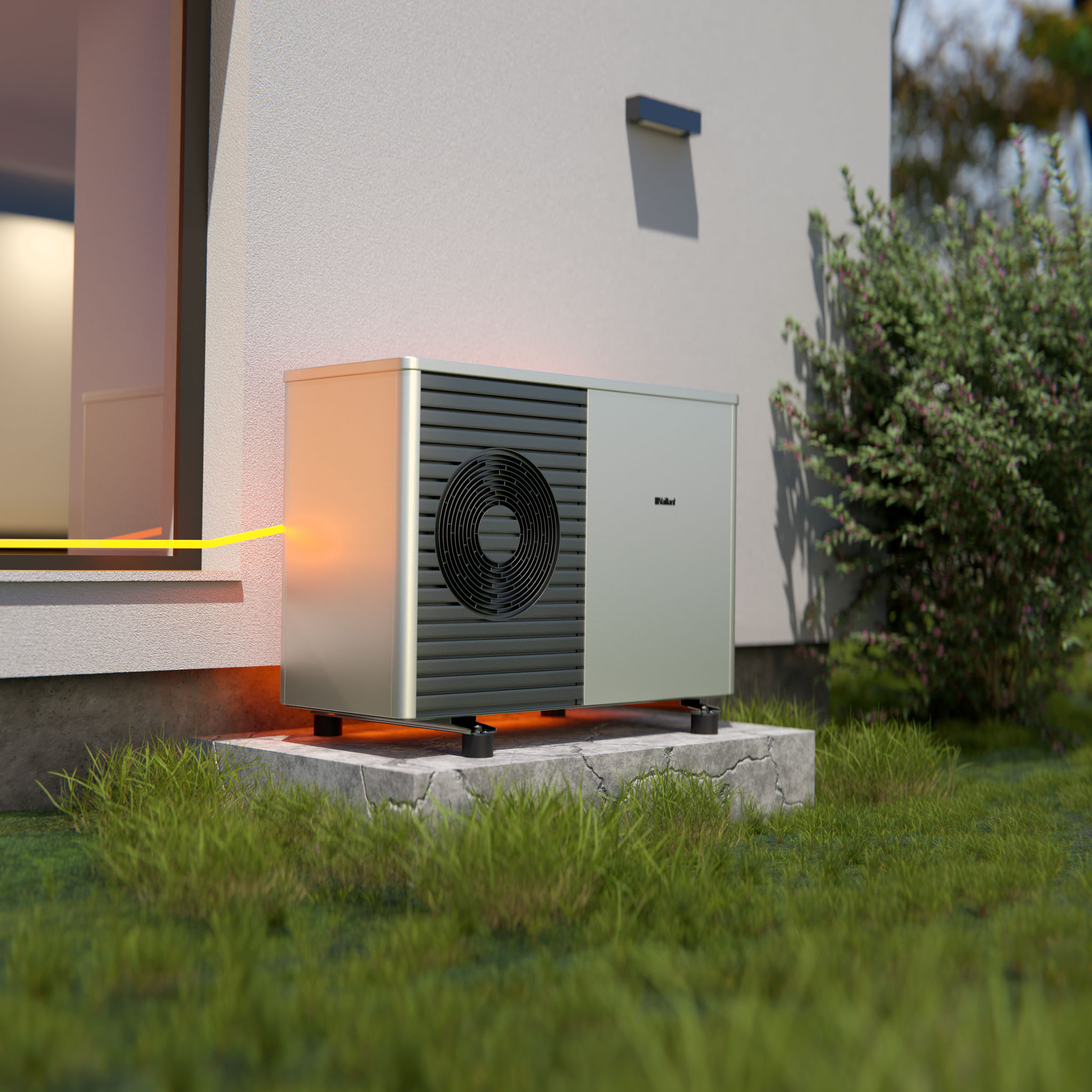 Wärmepumpe als Teil des Energiesystem, Sommermotiv mit grünem Rasen und Büschen